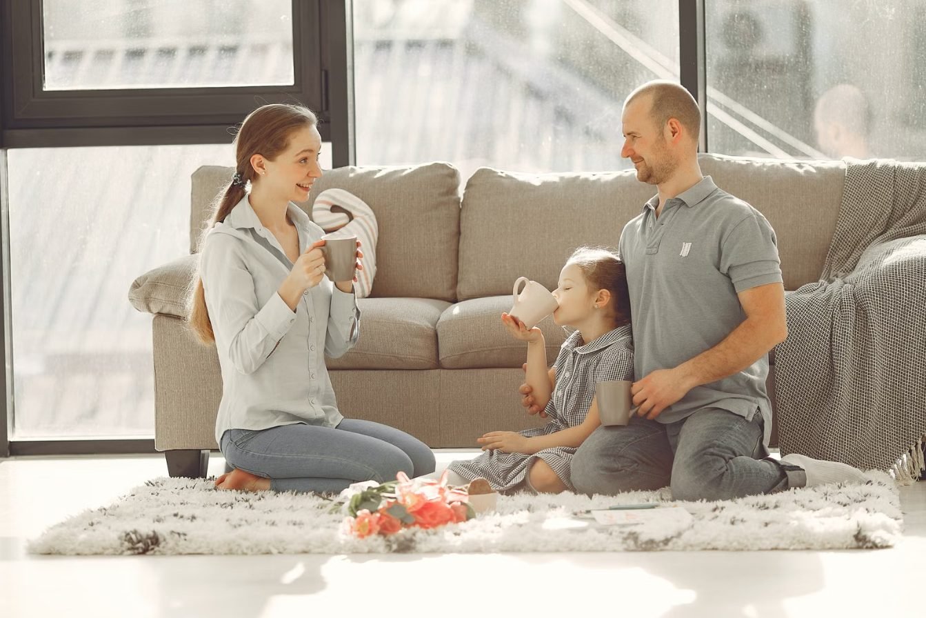 Parents and their young daughter spending time together at home